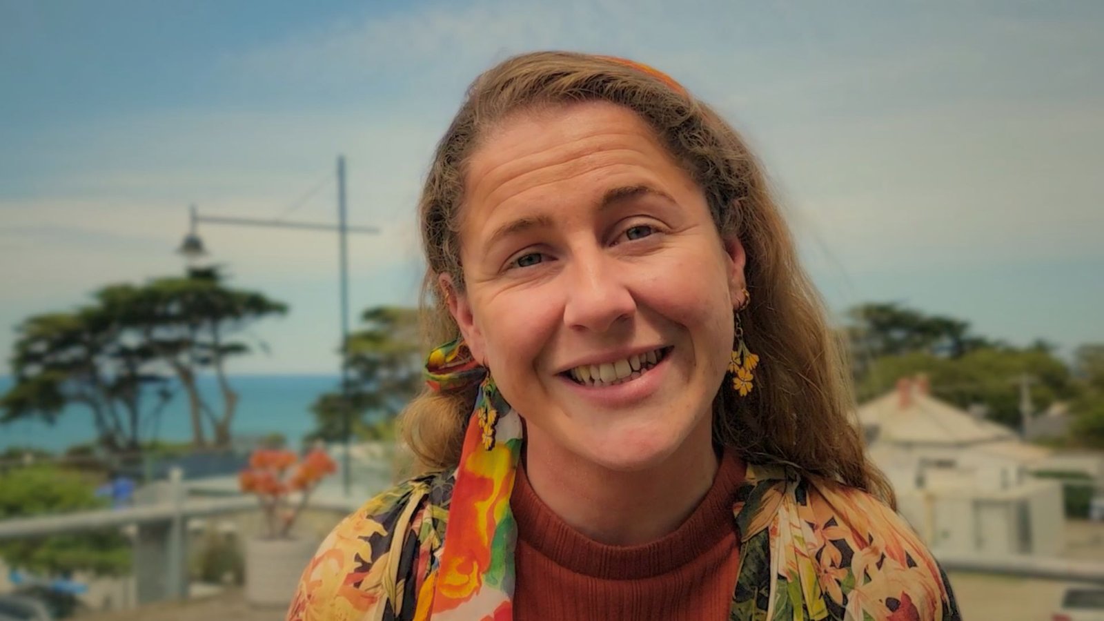 Paz from The Community Collective smiling outdoors, featured for her Happy Spaces success story about finding inspiration and connection at the Coworking Space Torquay.