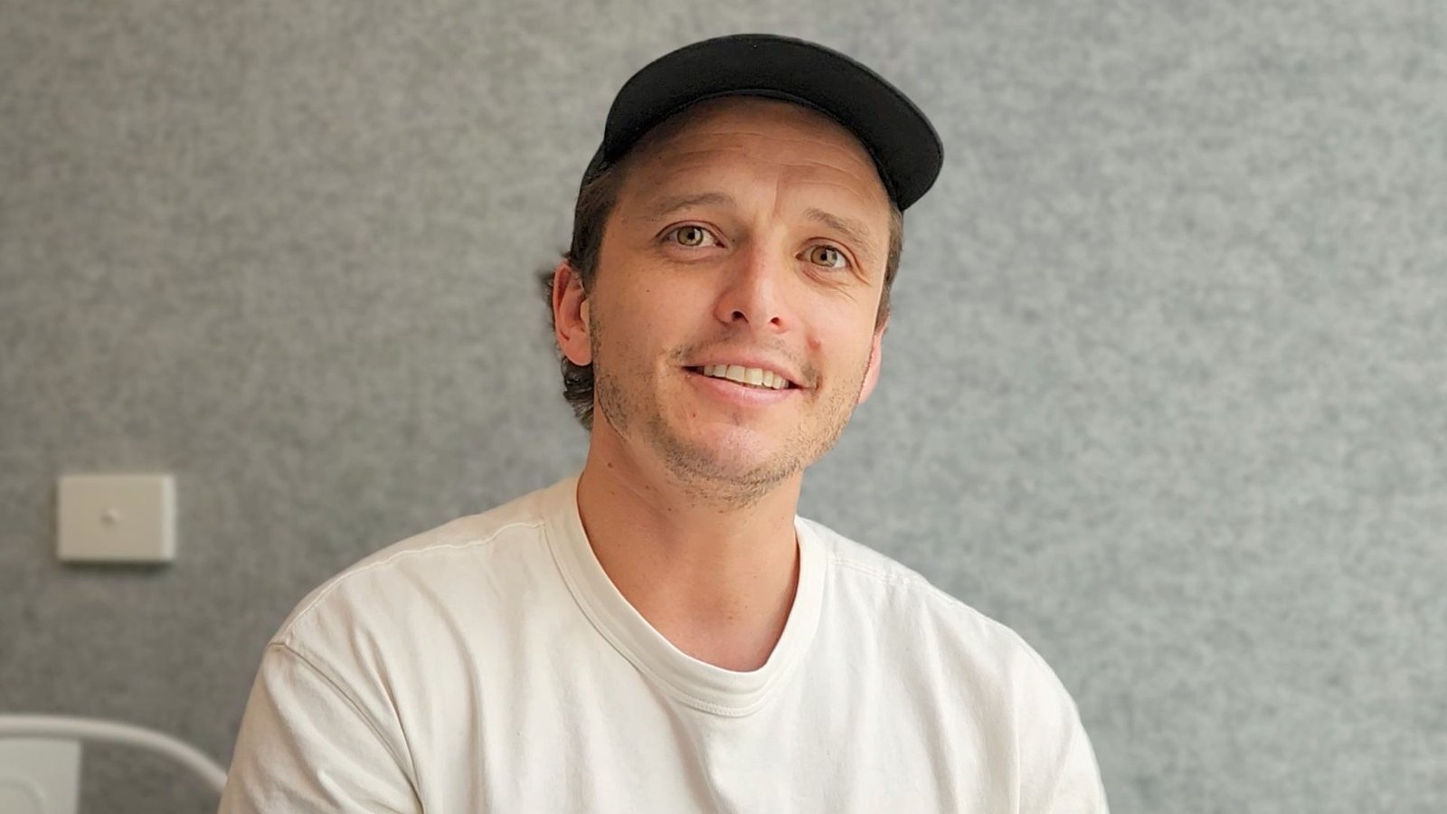 Sam from Assemble Agency smiling, featured for his Happy Spaces success story about finding a professional vibe without office politics. Title: Happy Spaces Member Sam - Professional Vibe Story